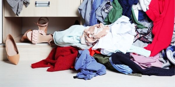 pile of clothes causing clutter around the home